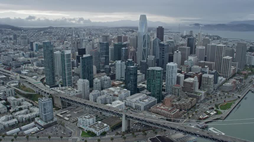  aerial footage capturing an flyby of Downtown San Francisco skyscrapers showcasing the city's impressive high rises against a cloudy backdrop in Northern California