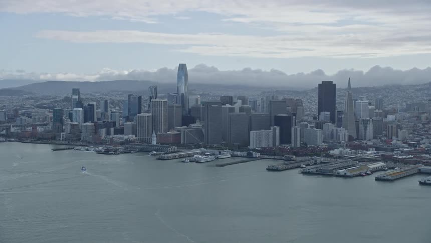 an aerial view of the Downtown San Francisco skyline on a cloudy day showcasing the city's iconic high rise towers and skyscrapers