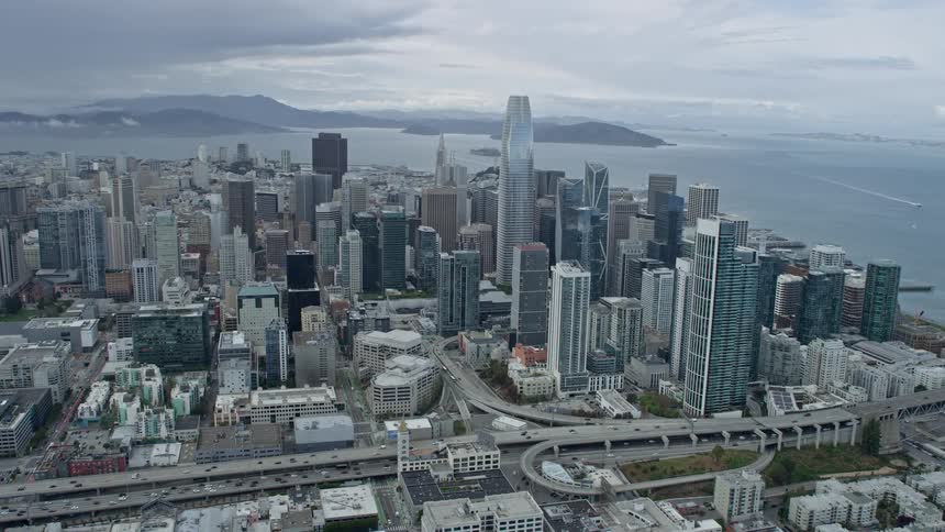  aerial video footage capturing the majestic skyscrapers and high-rise buildings of Downtown San Francisco California as the camera glides past them on a cloudy day - shot over SF Bay Area with a Shotover F1 showcasing the city's superstructures and super