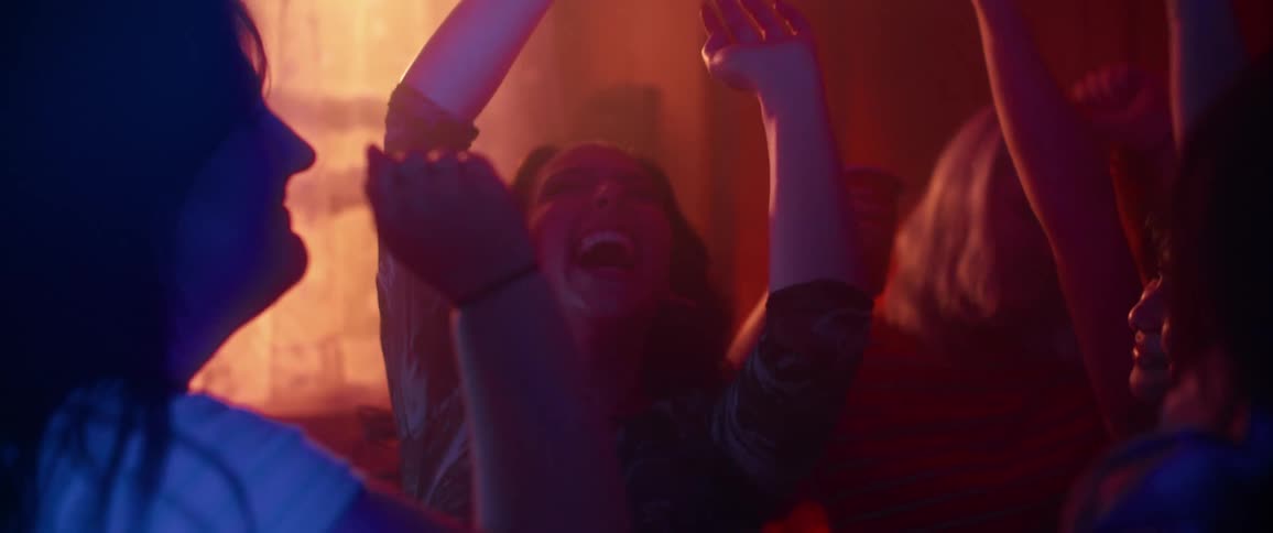 A group of women dancing and smiling at a party