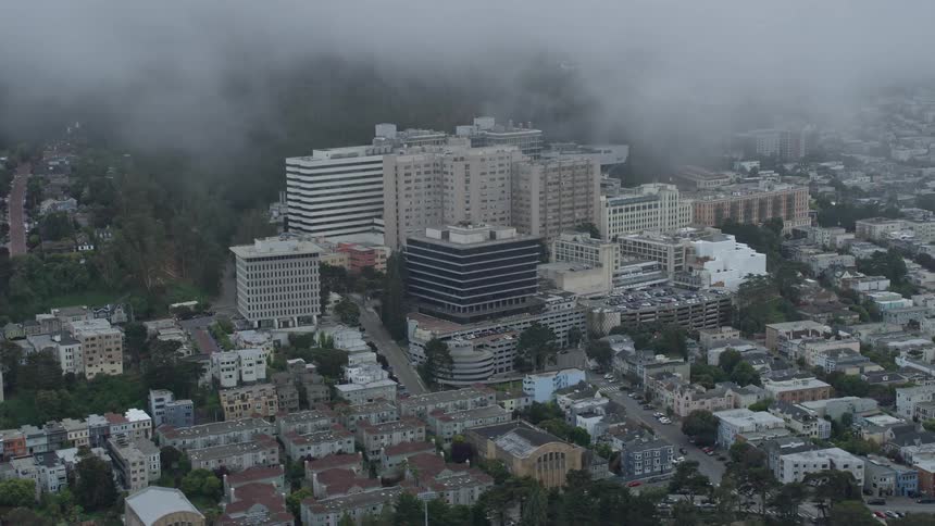 Aerial view of UCSF Medical Center in the Inner Sunset District San Francisco California with cloudy skies and fog in the background