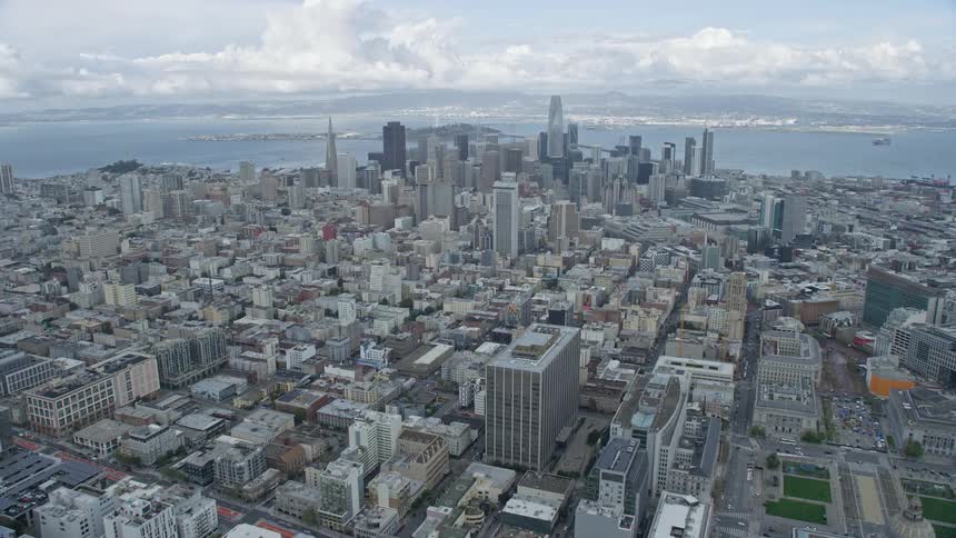 Aerial footage of San Francisco's Downtown skyline on a cloudy day approaching from Western Addition