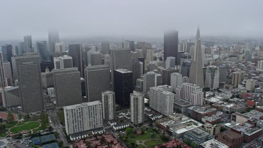 Aerial view of foggy Downtown San Francisco skyscrapers during the day in Northern California