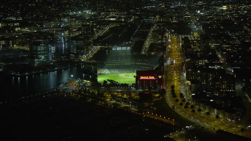  aerial footage of Oracle Park stadium illuminated at night showcasing the clear skies and vibrant atmosphere of San Francisco's baseball stadium during summer in the Bay Area California