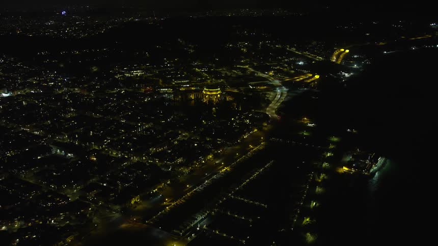 Approaching the iconic Palace of Fine Arts at night in San Francisco California with clear skies and a view of the city in thisaerial stock footage captured during the summer