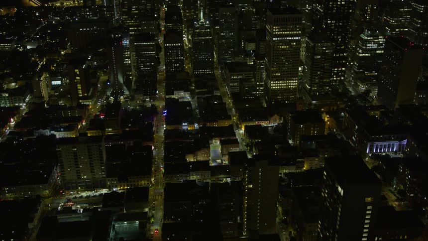  aerial footage circling above San Francisco's Chinatown at night showcasing the city's office buildings apartment and residential buildings and bustling city streets