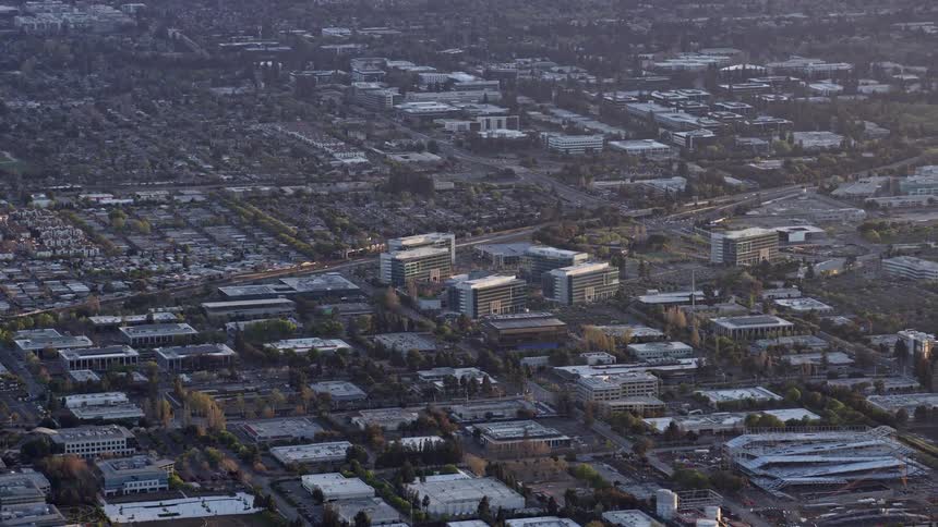  aerial footage capturing the magnificent sunset over a cityscape of office buildings in Sunnyvale California providing an view of the industrial hub nestled in the Bay Area during the enchanting spring season