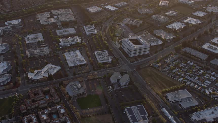  aerial footage capturing the stunning sunset as the camera approaches and orbits the Samsung corporate office building in San Jose California