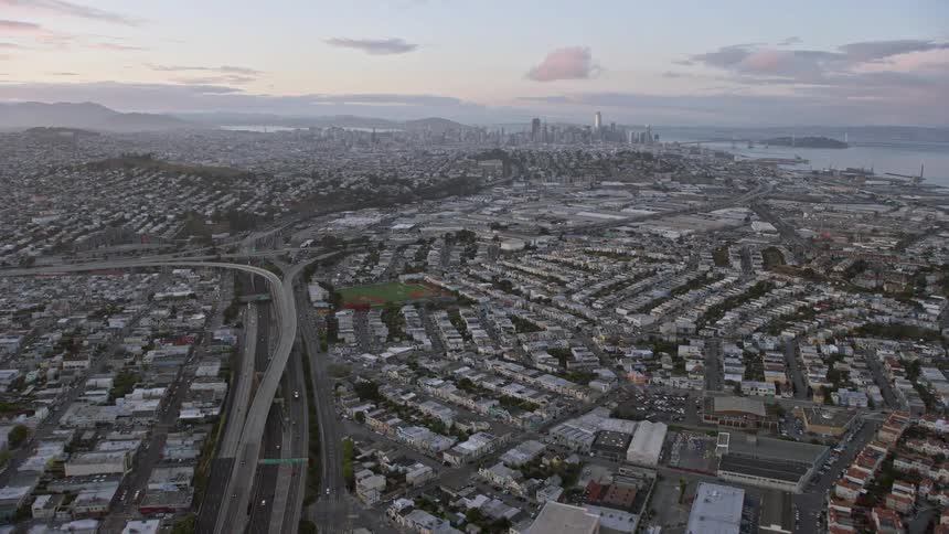 A majesticaerial footage capturing the beautiful sight of the San Francisco skyline during sunset as the camera tilts up from the 101 freeway revealing the cityscape in all its glory
