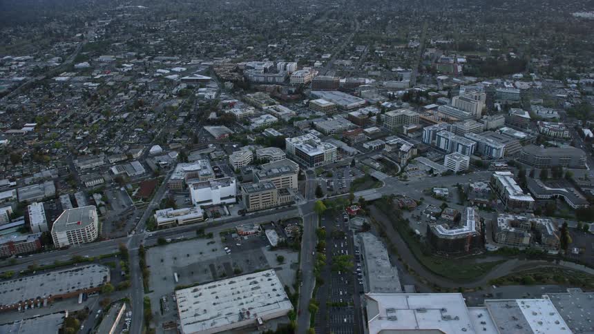  aerial footage of Kaiser Permanente Medical Center buildings at sunset in Redwood City California with a partly cloudy sky showcasing the medical and health services available on the San Francisco Peninsula
