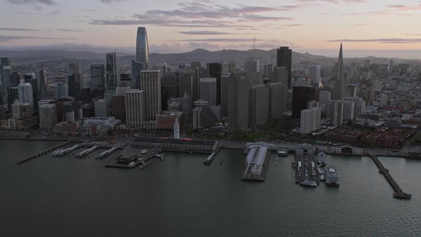 an flyby of Downtown San Francisco skyscrapers at sunset showcasing the city's high-rise buildings and the beautiful California skyline