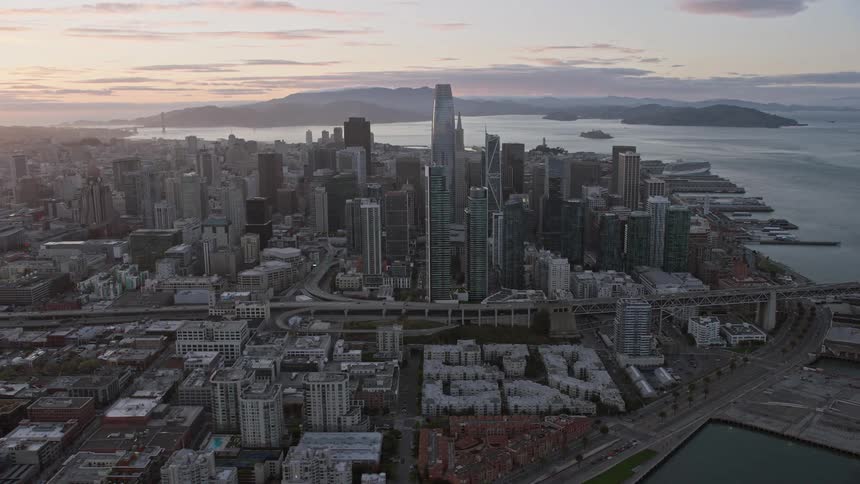 an aerial view of the San Francisco skyline at sunset with skyscrapers towering over the city as seen from the side in Northern California's Bay Area capturing the essence of California's urban beauty during summertime
