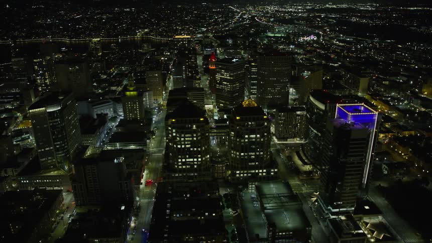  aerial footage of Downtown Oakland at night showcasing the iconic Oakland City Hall and government office building with clear skies and bright city lights illuminating the landscape