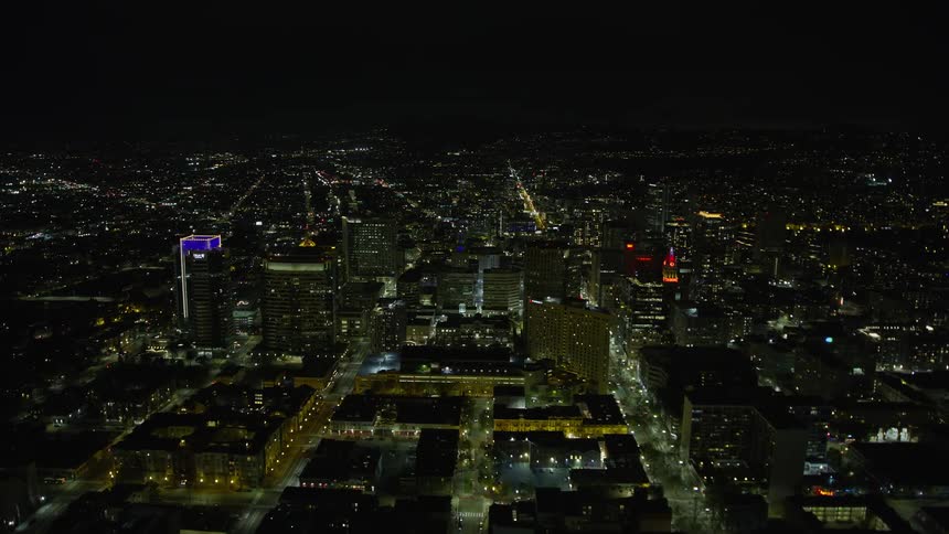  aerial stock footage of Downtown Oakland at night showcasing the illuminated office buildings and vibrant city lights in California's Bay Area | Tags: night clear skies office buildings downtown nighttime city California Oakland