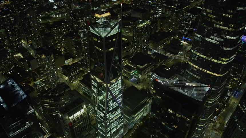 An exhilarating aerial view of a stunningly illuminated downtown San Francisco skyscraper during a clear night showcasing the modern architecture of the city in Northern California