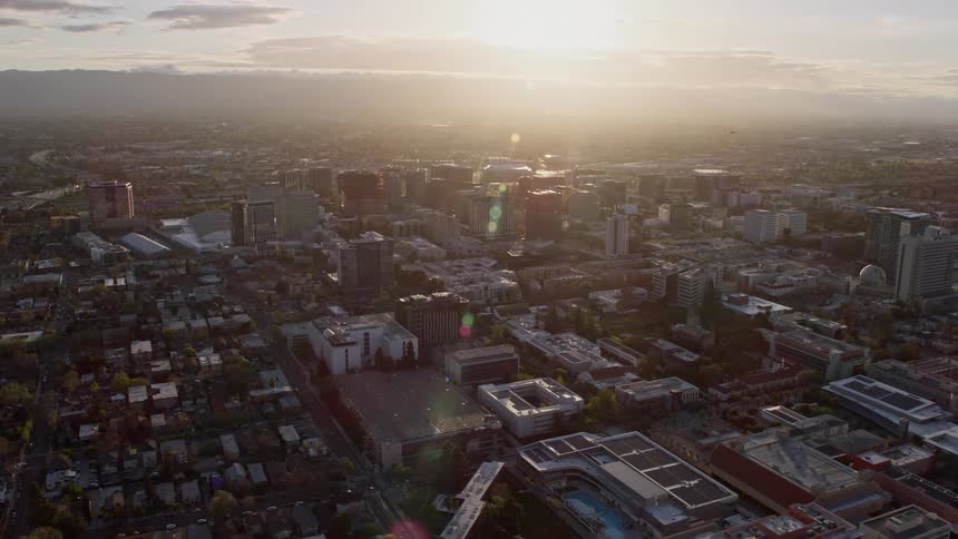 an aerial view of Downtown San Jose at sunset California capturing the hazy atmosphere and the vibrant cityscape of the Bay Area