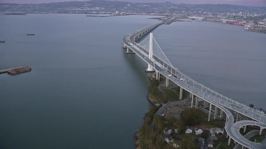 Captivating aerial view of the iconic Bay Bridge at sunset in California showcasing its impressive span and stunning surroundings