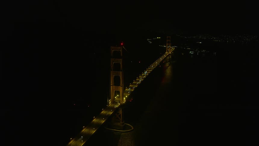  aerial footage capturing the iconic Golden Gate Bridge at night with light traffic and clear skies in Northern California
