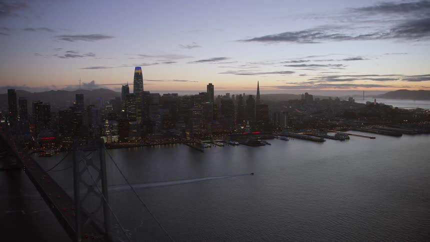 Traffic travels over the bridge towards the city