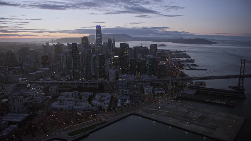 Twilight aerial view of Downtown San Francisco skyscrapers and Bay Bridge during summer in California