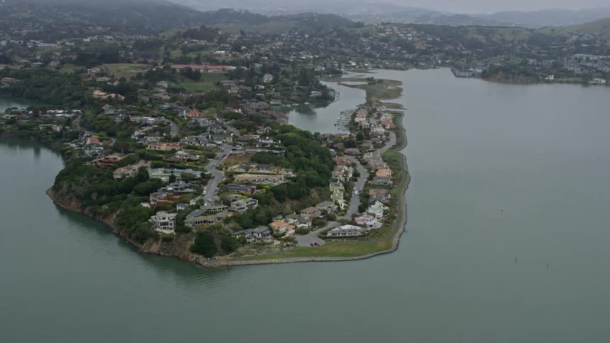  aerial footage showcases stunning waterfront mansions in Mill Valley on a foggy day offering a glimpse into the luxurious residential estates of Northern California's Bay Area