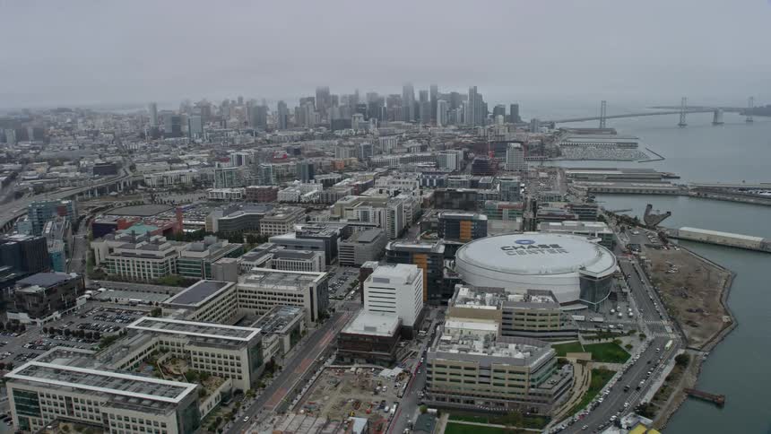 Aerial view of downtown San Francisco skyscrapers on a foggy day as seen from Chase Center showcasing the city's iconic landmarks and urban landscape