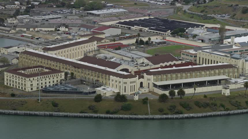 Aerial view of San Quentin State Prison in Northern California showcasing the government building situated on the coast of the water during daytime