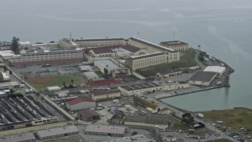 Aerial footage captures an overcast day as the camera circles San Quentin State Prison a government building in the San Francisco Bay Area California