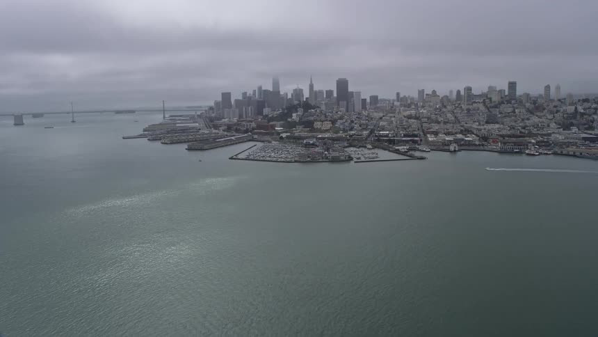 A stunning aerial view of the Downtown San Francisco skyline on a foggy day in Northern California showcasing the high rise buildings and cityscape