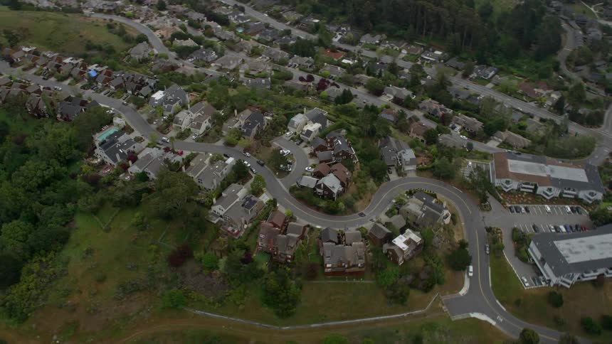 Aerial footage of suburban homes in Mill Valley California on a foggy day showcasing the peaceful neighborhood and overcast ambiance