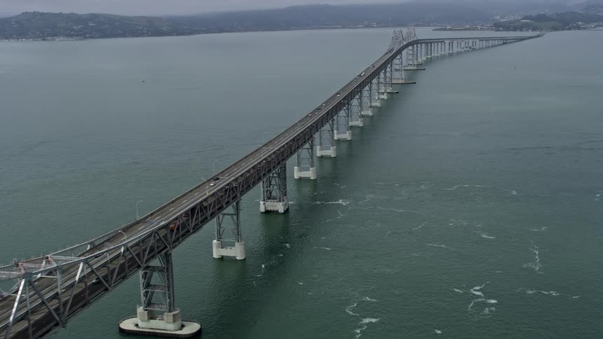 Aerial footage of light traffic on the Richmond Bridge in California during a sunny day