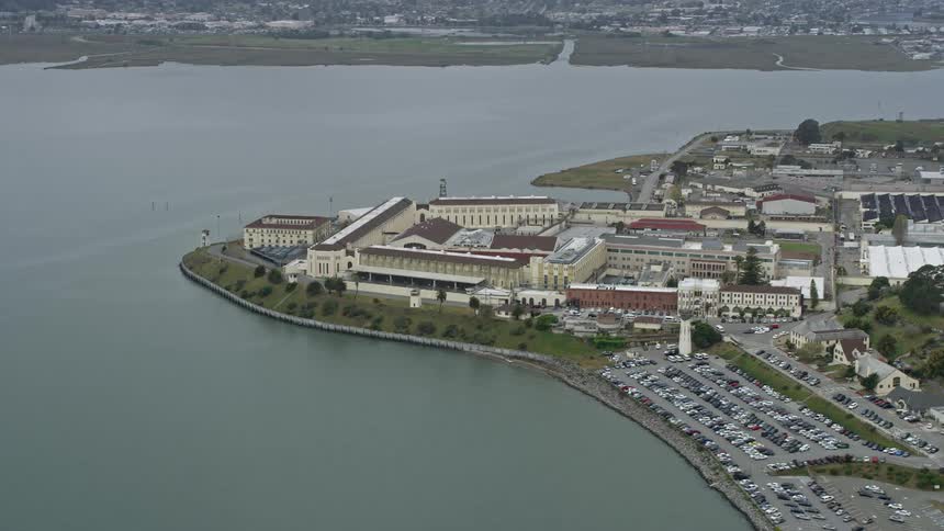 Aerial footage circling San Quentin State Prison a government building in Marin County California located in the San Francisco Bay Area showcasing the penitentiary during daytime