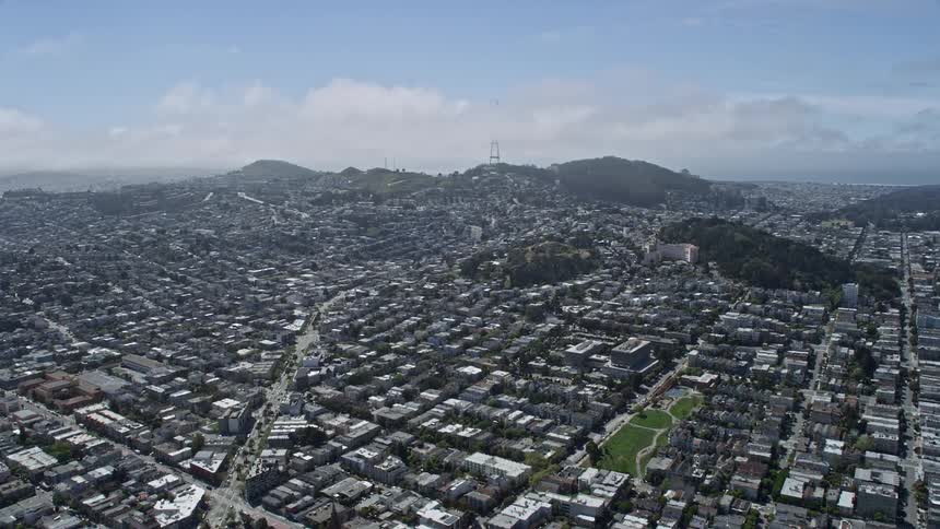  aerial footage of a sunny day in California flying over urban neighborhoods and approaching the iconic Sutro Tower in San Francisco while capturing the residential and scientific facets of the city