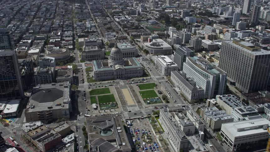  aerial footage of approaching City Hall in Civic Center San Francisco California with partly cloudy skies and a POV shotover of the government building capturing the beauty of the Bay Area in the spring/summer