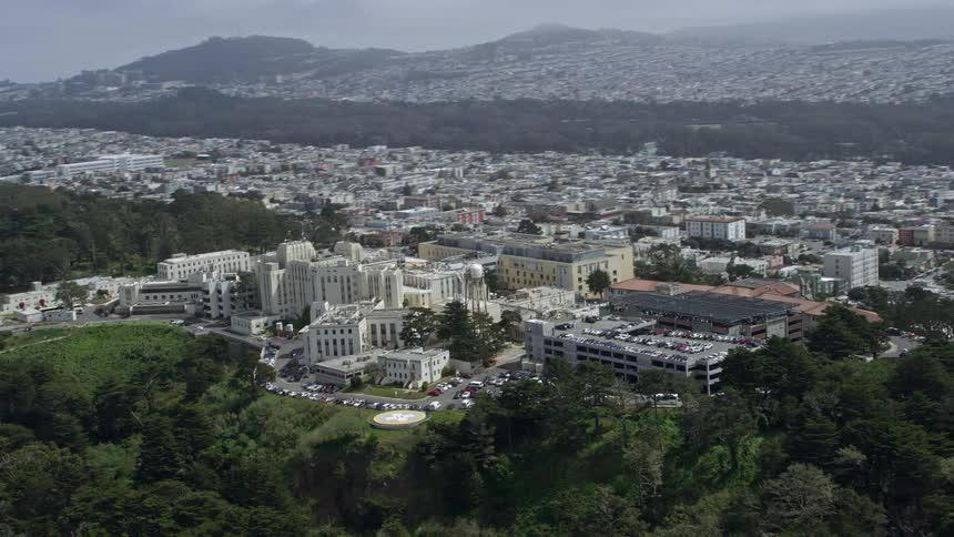  aerial footage of a hospital overlooking the ocean in Seacliff San Francisco California during daytime with partly cloudy skies