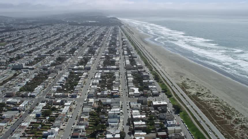 Aerial footage capturing the scenic coastal road and residential areas of Outer Sunset District overlooking the shores of Ocean Beach in San Francisco California