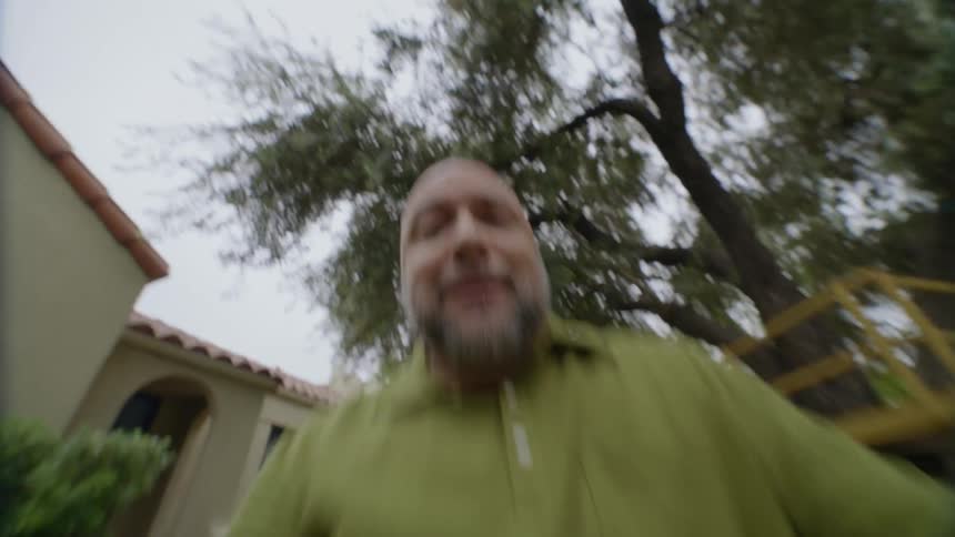 Man holding an animal treat as something goes towards him