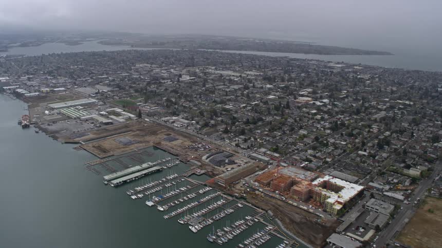  aerial footage showcasing the foggy Alameda residential neighborhoods in California as the camera approaches the city on a summer day