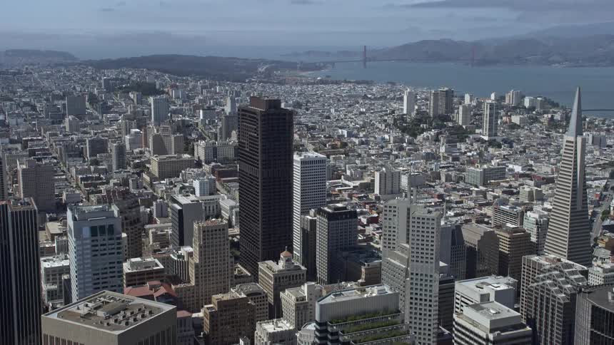 A stunningaerial view of the high-rise buildings in downtown San Francisco California captured during a sunny day providing an flyover perspective of the city's skyline