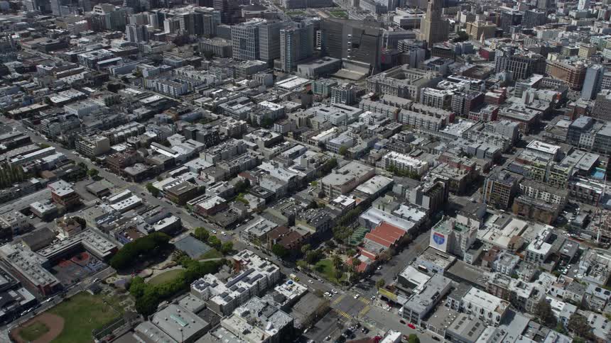  aerial footage showcasing the urban neighborhood of South of Market in San Francisco California featuring multi-level buildings and skyscrapers captured during a partly cloudy day providing a unique perspective and approach to the residential area