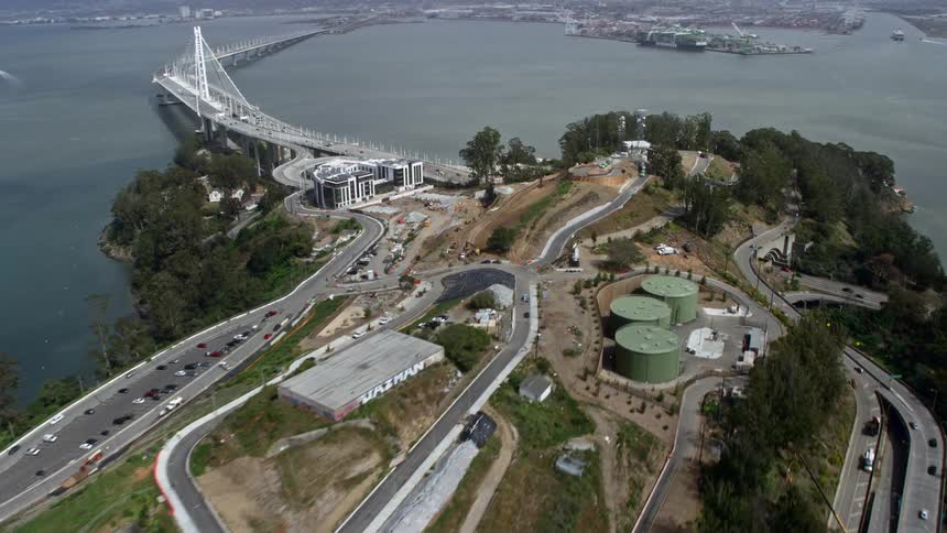 Approaching Yerba Buena Island this aerial footage captures a tilt down to a condominium complex on a cloudy day in Northern California's Bay Area