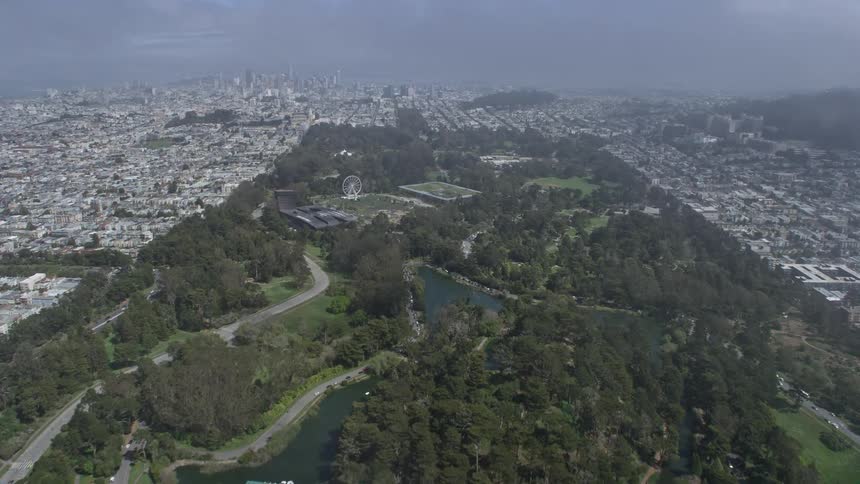  aerial footage of a daytime fly over Golden Gate Park in San Francisco California with partly cloudy skies and a wide-angle POV shot
