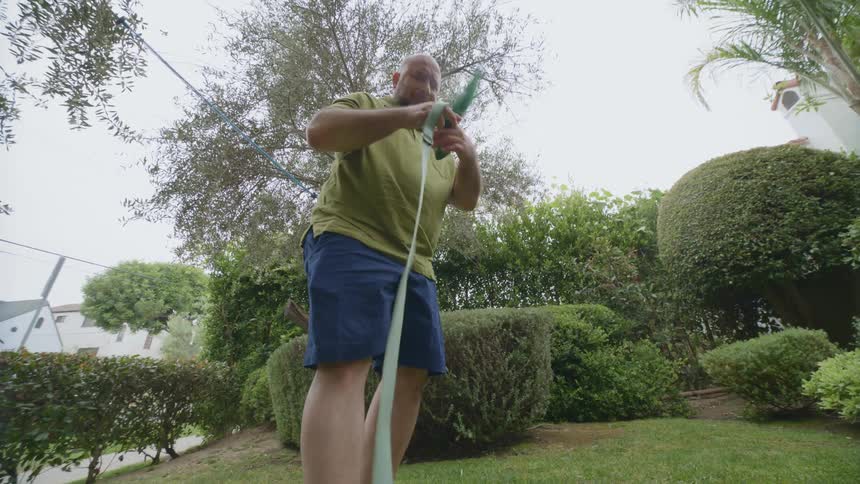 Man picking up animal feces in the garden