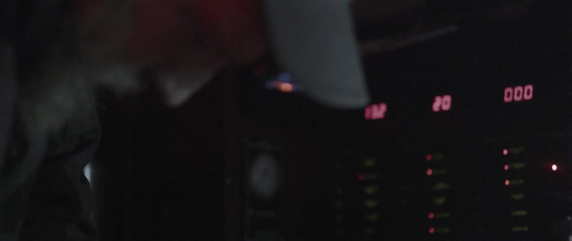An older male turns on a headlamp on his forehead and looks at an instrument panel