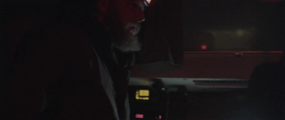 Two people are talking and working in the dark