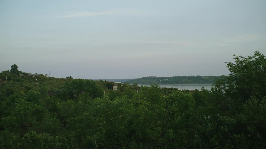 House in a hill next to a lake in a rural area