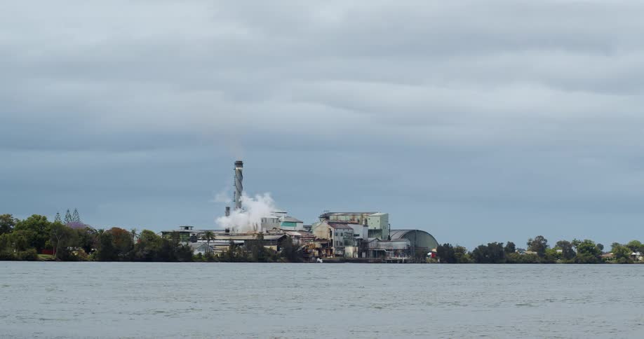 Coastal city skyline with power plant with trees around