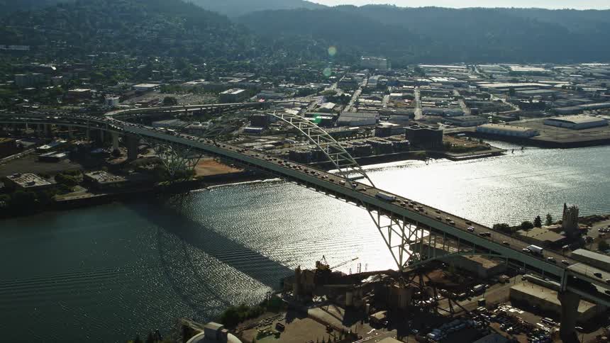 Aerial footage of the Fremont Bridge and downtown Portland buildings showcasing the city's high-rise towers and transportation on a sunny day