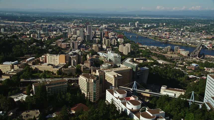 Aerial footage of downtown Portland Oregon showcasing the Oregon Health and Science University and the surrounding cityscape