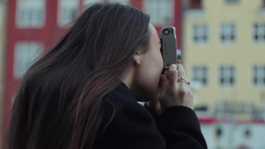 Woman taking a picture with the camera